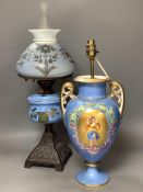 A French porcelain blue ground vase (converted to electricity) and a glass oil lamp,with cast metal