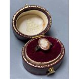 A yellow metal and oval cameo shell set child's ring,size D, gross 1.4 grams.