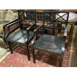 A pair of George III style ebonised elbow chairs