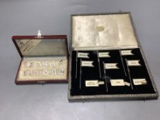 A cased set of twelve Dutch white metal number place settings, 12mm and a cased set of six silver