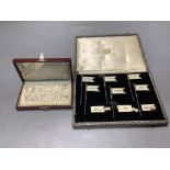 A cased set of twelve Dutch white metal number place settings, 12mm and a cased set of six silver