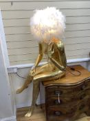 A large gilded seated female mannequin with illuminating feather shade, height 130cm