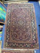 A Kashan burgundy ground rug, 208 x 135cm