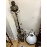 A wrought iron oil-fired floor lamp with reservoir and chimney a hanging Aladdin oil lamp with