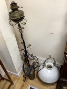 A wrought iron oil-fired floor lamp with reservoir and chimney a hanging Aladdin oil lamp with