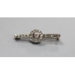 An early 20th century white metal (stamped 9ct) and diamond target cluster set bar brooch,31mm,