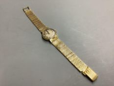 A vintage ladies' Omega 18ct gold ladys' wristwatch on integral mesh bracelet,having circular