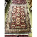 A Caucasian design red ground carpet, 310 x 228cm