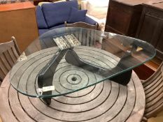 A Isamu Noguchi style coffee table,the triangular heavy glass top (approximately 2cm thick) on