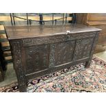 A 17th century carved oak cofferwith planked top, length 121cm, depth 51cm, height 67cm