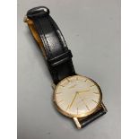 A gentleman's 1960's 9ct gold Longines manual wind wrist watch, on associated leather strap, case