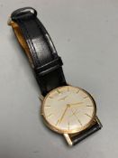 A gentleman's 1960's 9ct gold Longines manual wind wrist watch, on associated leather strap, case