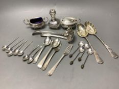 A three-piece silver condiment of oval half-reeded form, two silver sifter spoons, a pair of silver