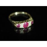An early 20th century 18ct gold, three stone ruby and four stone diamond chip set half hoop ring,