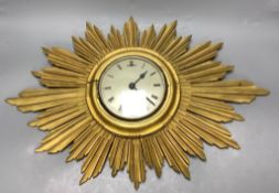 A giltwood sunburst wall clock, length 60cm