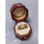 An early 20th century yellow metal, four stone ruby and single stone diamond set half hoop ring,