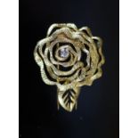 A 1980's French Cartier textured 18ct gold and diamond set 'open rose' clip brooch,numbered 9453,