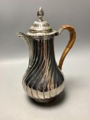 A George III silver hot water jug of wrythen baluster form,London 1766, possibly by Trevillion