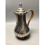 A George III silver hot water jug of wrythen baluster form,London 1766, possibly by Trevillion