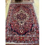 A Heriz style red ground carpet, 310 x 210cm