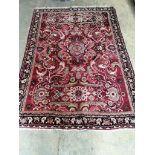 A North West Persian red ground rug, 210 x 140cm