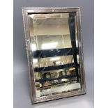 A late Victorian silver mounted rectangular easel mirror, with monogram applique, Drew & Sons,