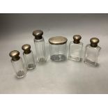 Six assorted silver mounted glass toilet jars, tallest 13.9cm.