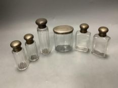 Six assorted silver mounted glass toilet jars, tallest 13.9cm.