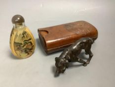 A bronze dog, a Chinese snuff bottle and a stamped leather cigar case