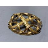 A Victorian engraved yellow metal mounted plaited hair interwoven oval scroll brooch,47mm, gross 8.