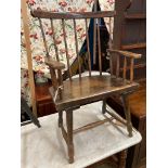 An early 19th century, possibly Welsh ash and fruitwood primitive Windsor comb back elbow chair,