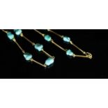 An early to mid 20th century Liberty & Co style gold baton link and turquoise pebble set necklace,