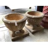 A pair of 19th century circular reconstituted stone garden planters on square plinth bases,