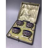A cased set of four Edwardian, pierced silver oval salts, with blue glass liners, Sheffield, 1904