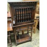 A 17th century style oak dole cupboard or food hutch,the door having spindle turned panel over