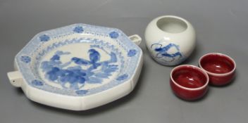 A Chinese blue and white water pot and two sang de boeuf cups and a plate warmer