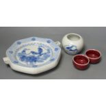A Chinese blue and white water pot and two sang de boeuf cups and a plate warmer
