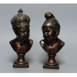A small bronze bust of a child wearing a crown and another small bronze bust of a child, tallest