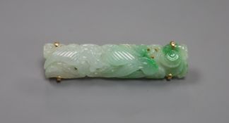 A 14k yellow metal and carved jade set bar brooch, 41mm,gross 6 grams.