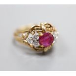 A stylish yellow metal, ruby and diamond set cluster ring, with single round cut ruby(crack),