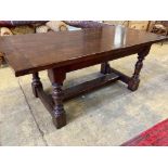 A 17th century style oak refectory tablehaving three-plank top on turned bulbous supports with H