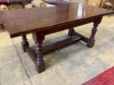 A 17th century style oak refectory tablehaving three-plank top on turned bulbous supports with H