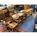 A Maple & Co oak dining suite of Italianate design, with carved and painted decoration and heraldic