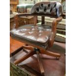 A mahogany and buttoned brown leather swivel desk armchair, width 60cm, height 84cm