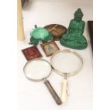 A French Art Deco green glass ashtray, a similar green glass Buddha, two magnifying glasses and a