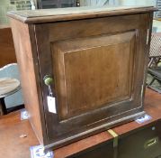 A Victorian mahogany cupboard, enclosed by a panelled door, width 60cm, depth 39cm, height 57cm