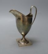 A George III silver helmet shaped cream jug, I.B, London, 1800, 14.9cm,114 grams.