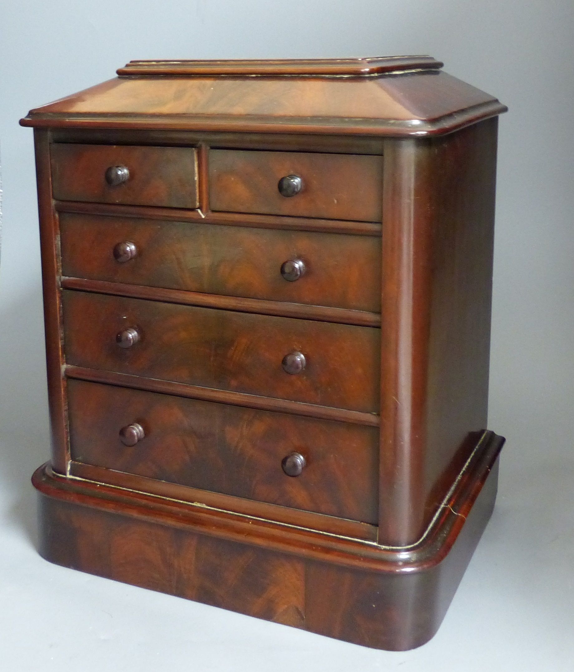 A Victorian miniature mahogany table top chest of drawers, height 35cm