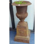 A pair of cast iron campana garden urns, height 112cm
