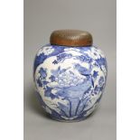 A late 19th / early 20th century Chinese blue and white jar, with wooden cover, height 25cm